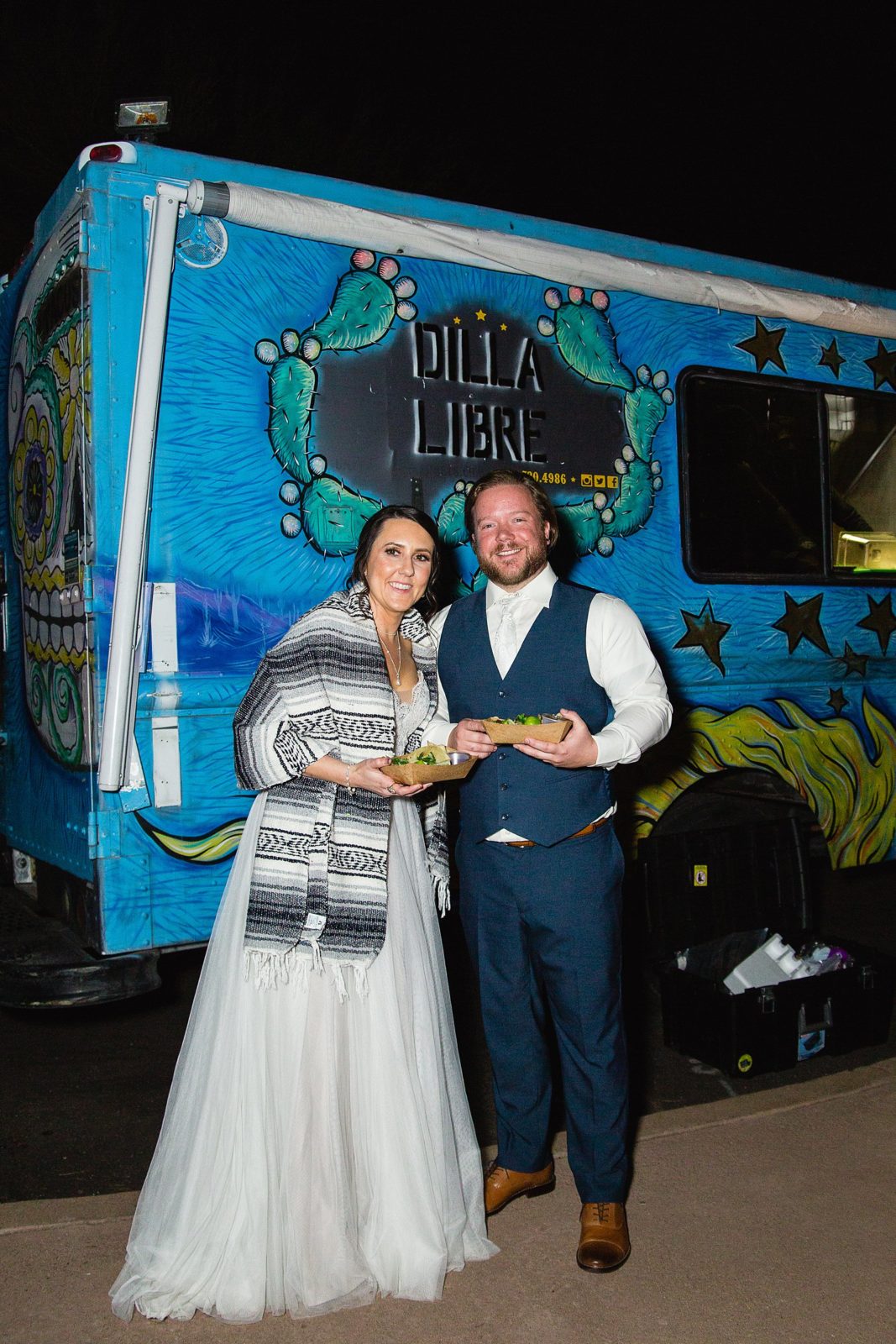 Bride and groom with their late night taco truck at their wedding reception by Arizona wedding photographer PMA Photography.