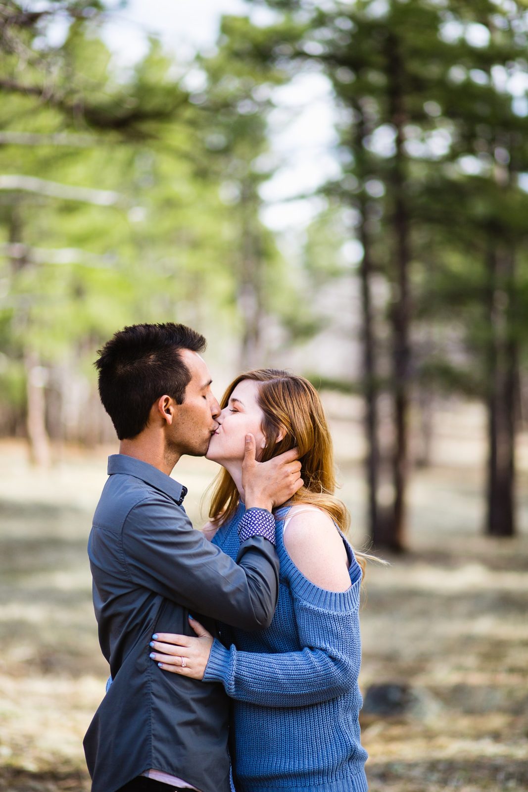 Couple share a kiss during their Buffalo Park engagement session by Flagstaff wedding photographer PMA Photography.