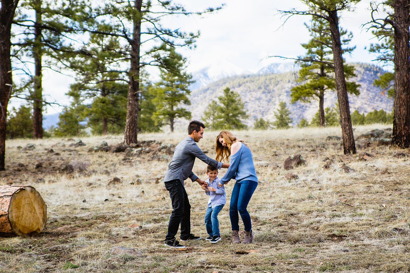 Couple laugh together with their son during their Buffalo Park engagement session by Flagstaff engagement photographer PMA Photography.