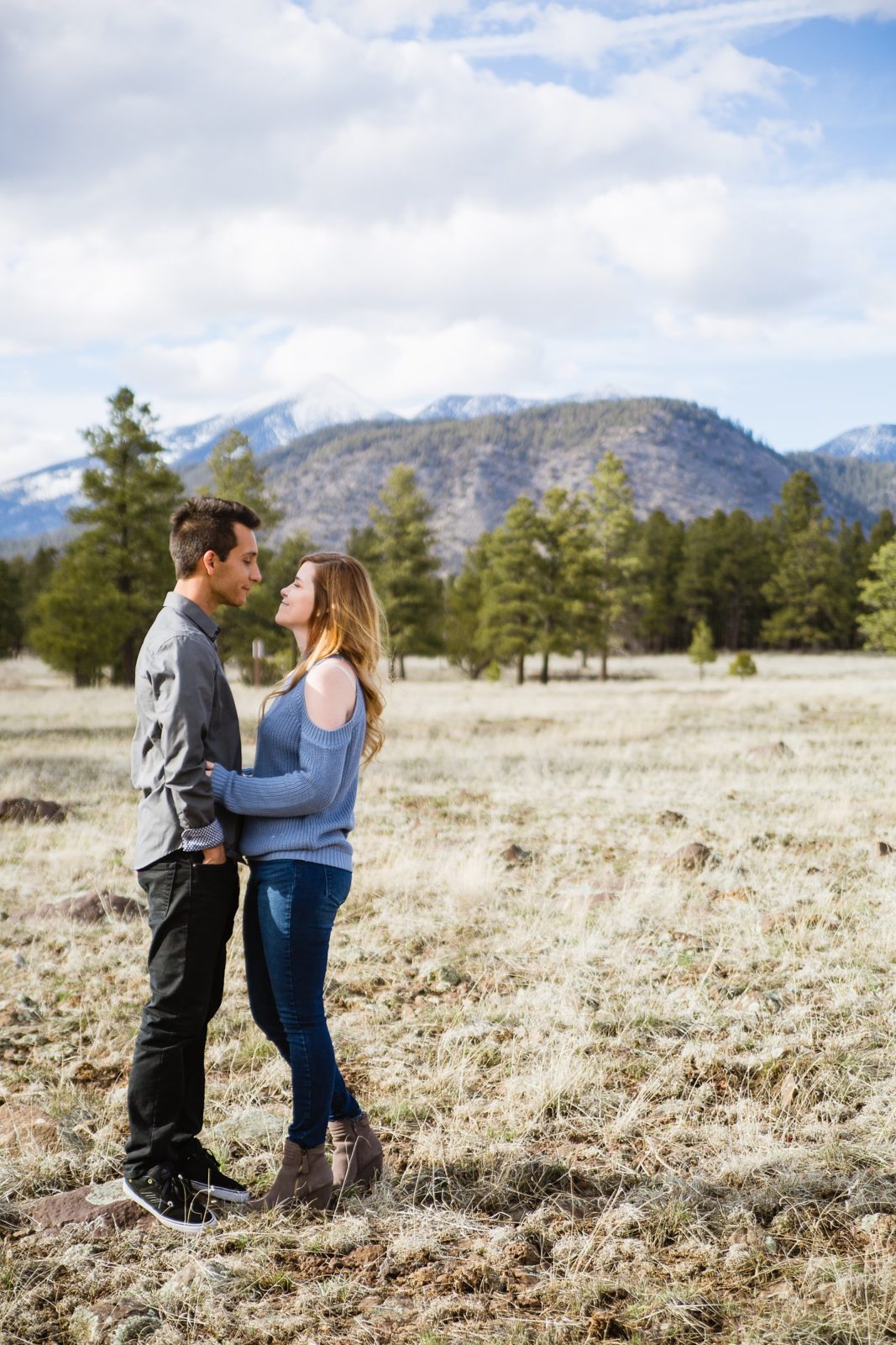 Couple pose during their Flagstaff engagement session by Arizona wedding photographer PMA Photography.