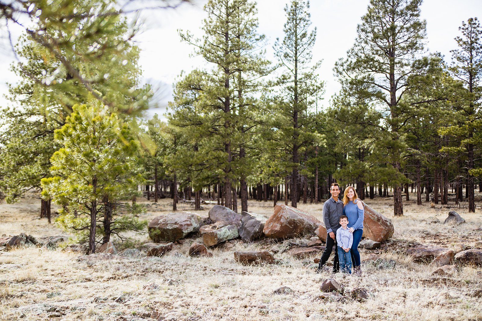 Couple pose with their son for their Buffalo Park engagement session by Flagstaff wedding photographer PMA Photography.