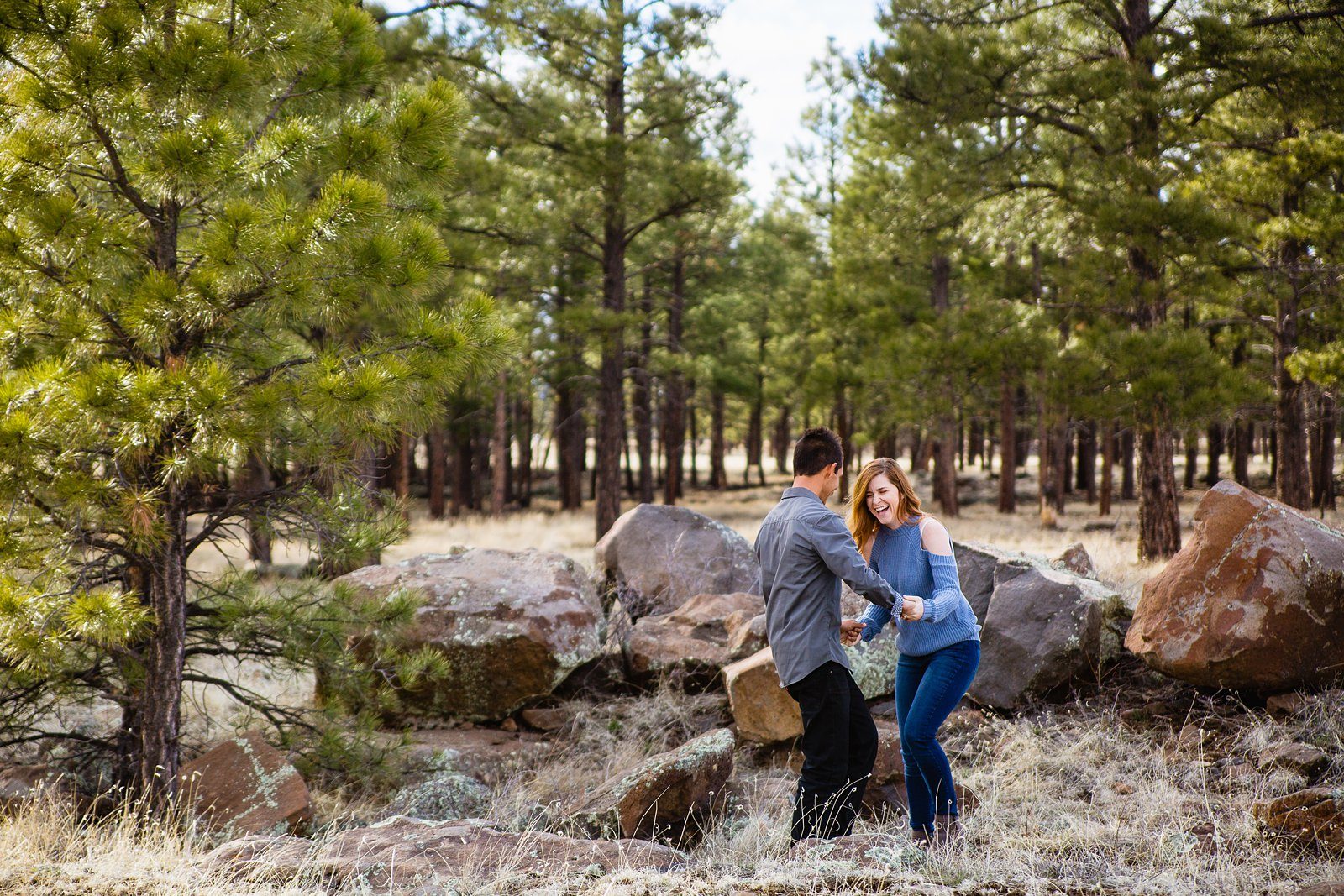 Couple laugh together during their Buffalo Park engagement session by Flagstaff engagement photographer PMA Photography.