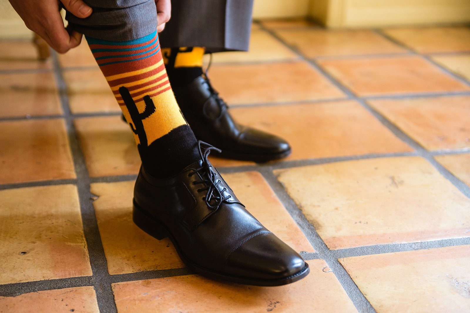 Groom's sunset cactus desert socks under his wedding day suit by PMA Photography.