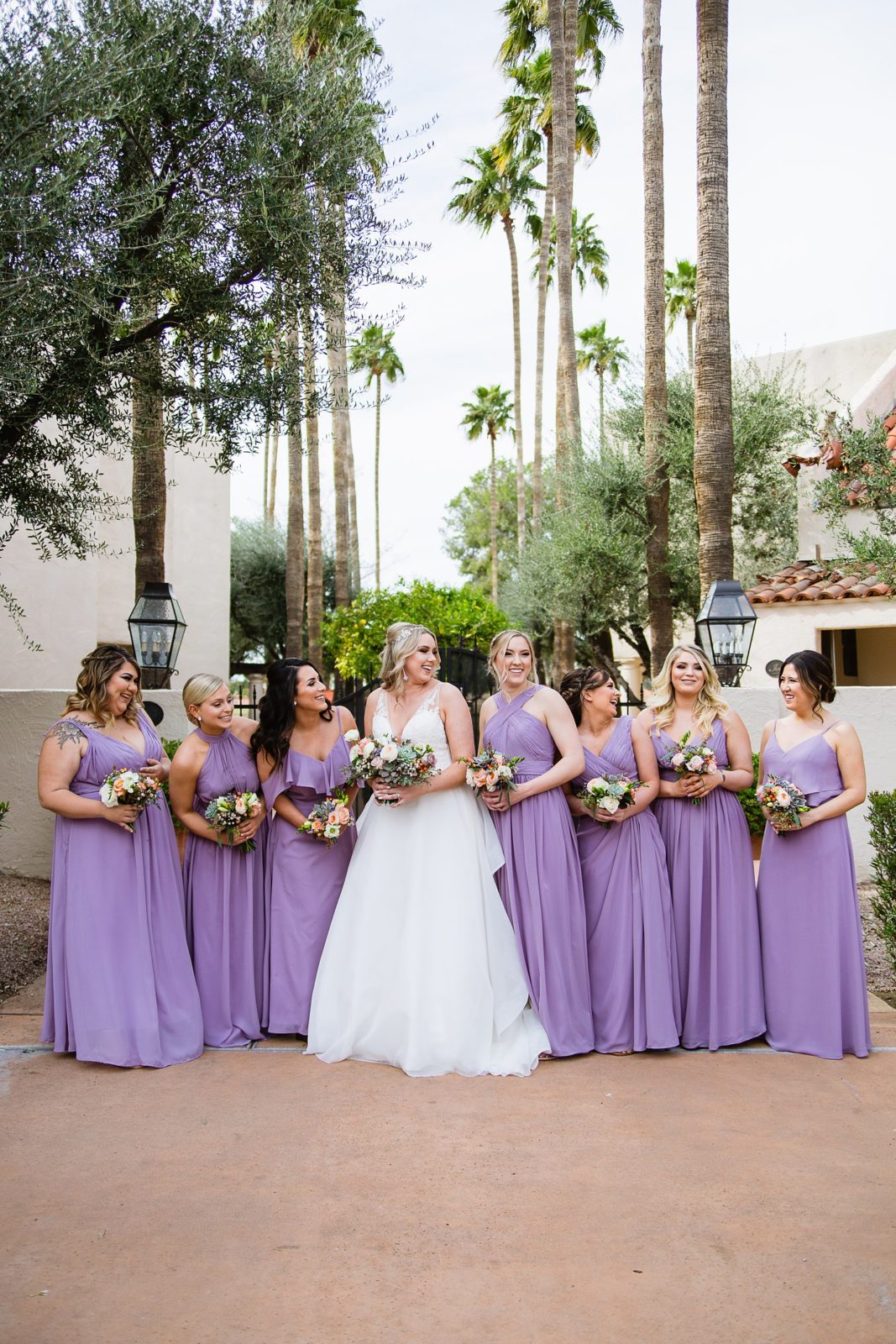 Bride and bridesmaids laughing together at The Scottsdale Resort at McCormick Ranch wedding by Scottsdale wedding photographer PMA Photography.