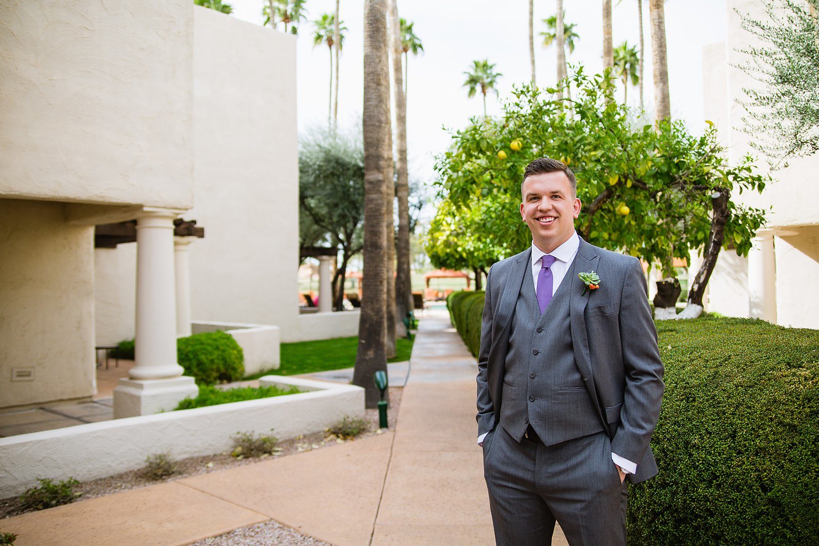 Groom's grey suit with purple tie for his The Scottsdale Resort at McCormick Ranch wedding by PMA Photography.