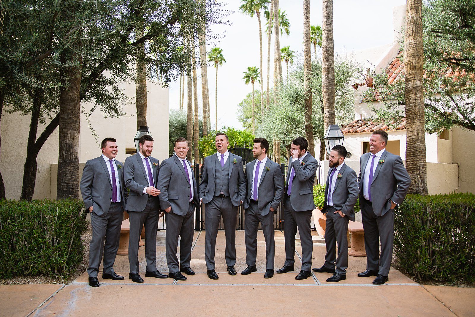 Groom and groomsmen laughing together at The Scottsdale Resort at McCormick Ranch wedding by Scottsdale wedding photographer PMA Photography.