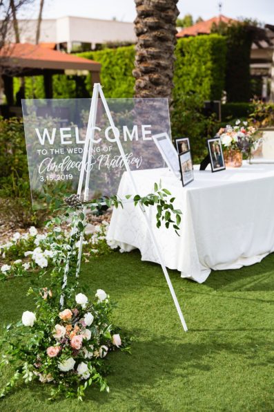 Modern wedding welcome sign decorated with florals by Bloom + Blueprint photographed by PMA Photography.