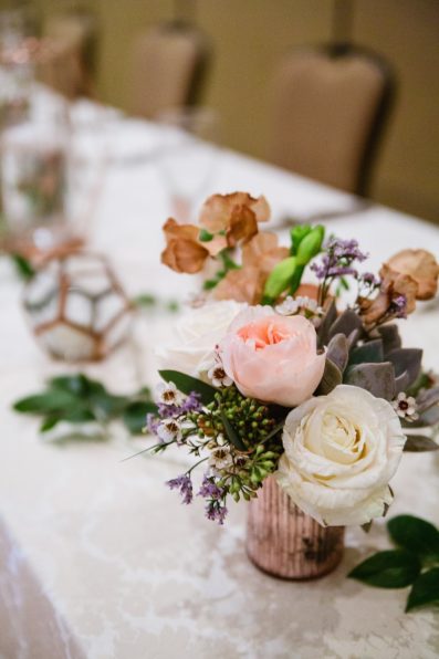 Romantic floral head table decorations photographed by PMA Photography.