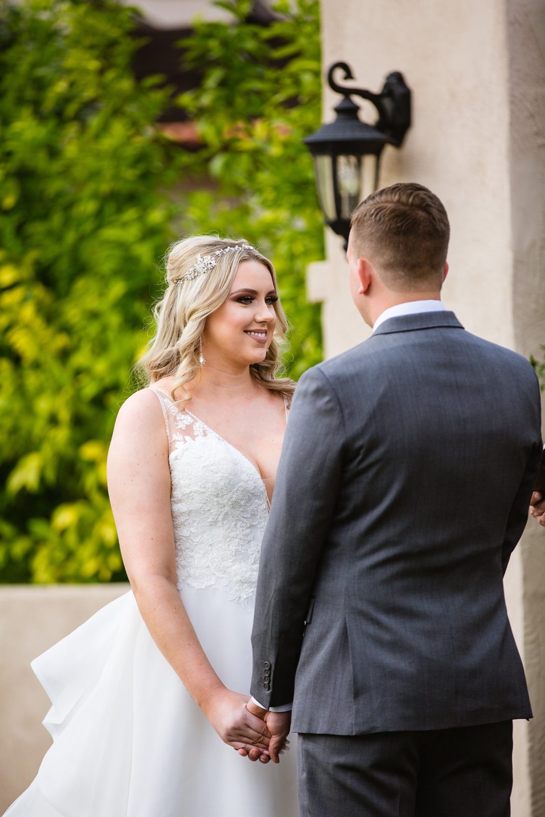 Bride looking at her groom during their wedding ceremony at The Scottsdale Resort at McCormick Ranch by Scottsdale wedding photographer PMA Photography.