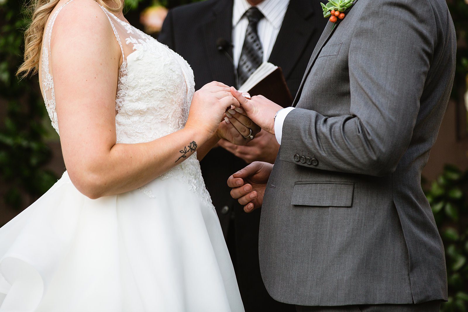 Bride and Groom exchange rings during their wedding ceremony at The Scottsdale Resort at McCormick Ranch by Arizona wedding photographer PMA Photography.