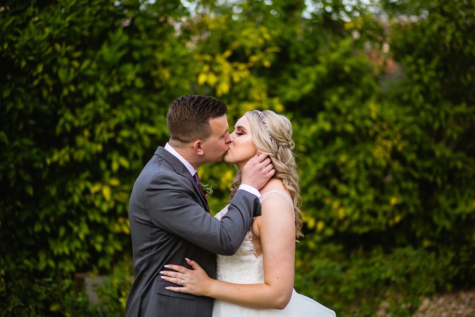 Bride and Groom share a kiss during their The Scottsdale Resort at McCormick Ranch wedding by Arizona wedding photographer PMA Photography.
