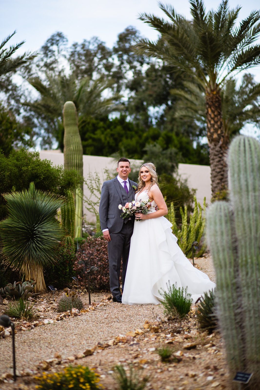 Bride and Groom pose for their The Scottsdale Resort at McCormick Ranch wedding by Scottsdale wedding photographer PMA Photography.