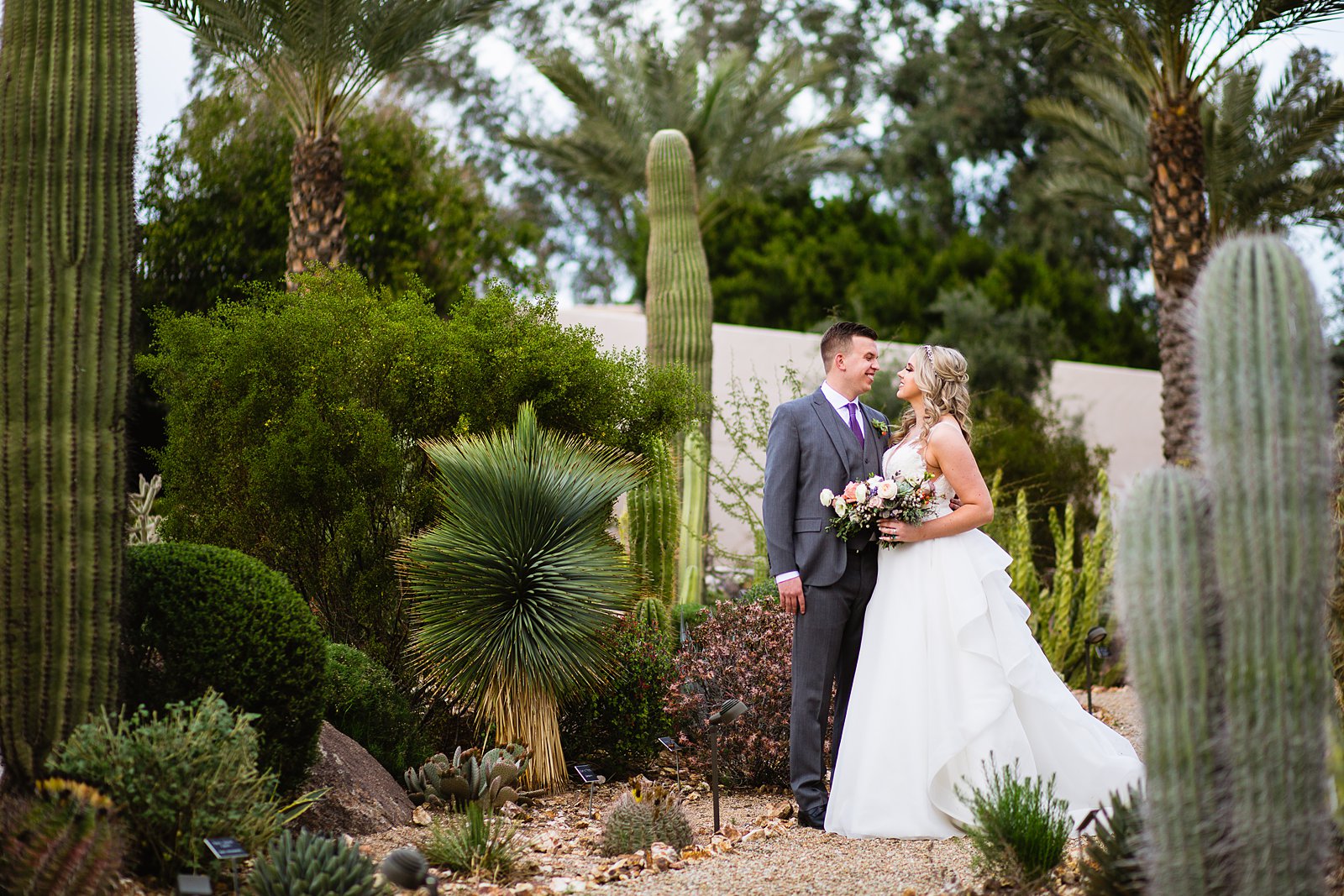 Bride and Groom pose during their The Scottsdale Resort at McCormick Ranch wedding by Arizona wedding photographer PMA Photography.