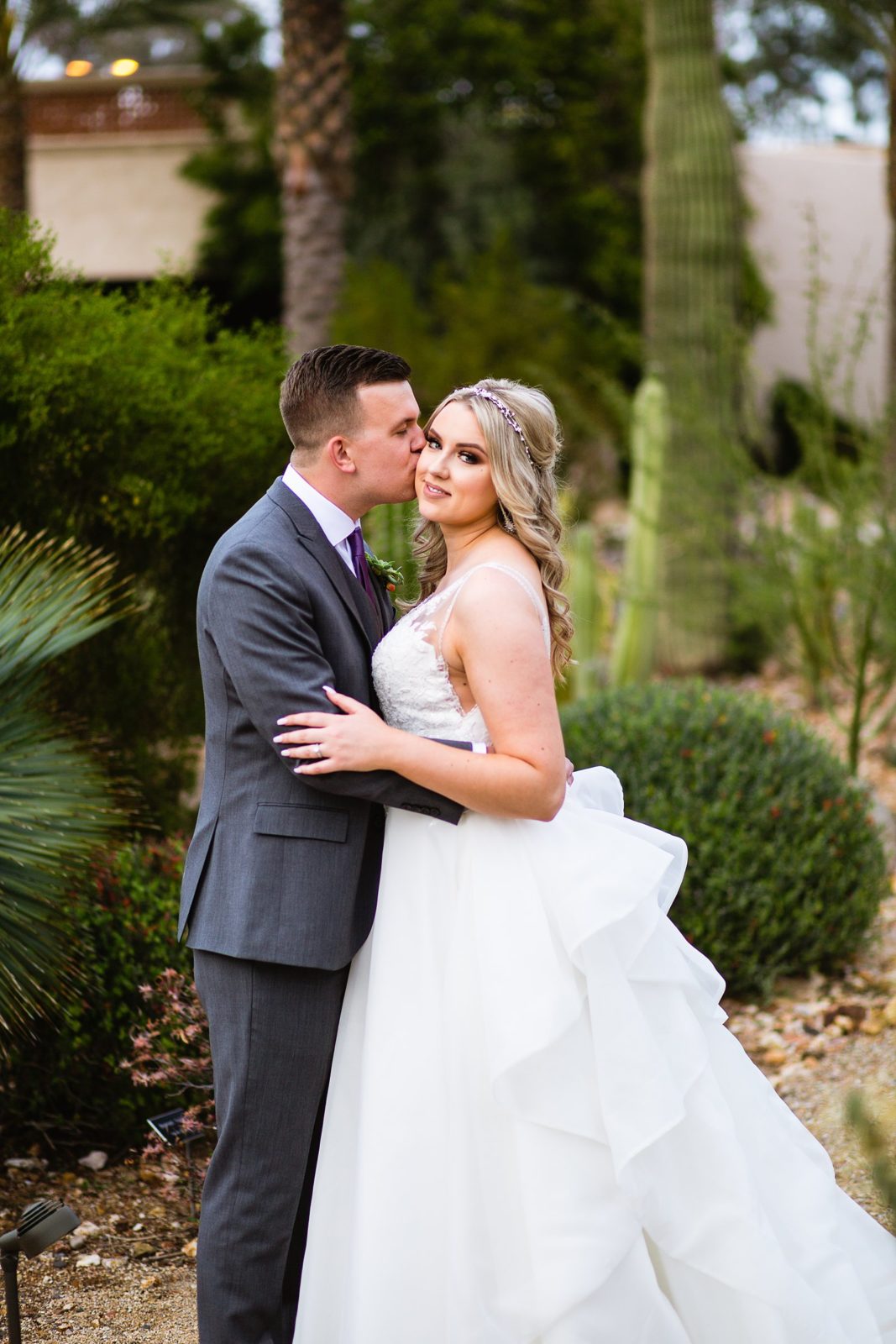 Bride and Groom share a kiss during their The Scottsdale Resort at McCormick Ranch wedding by Scottsdale wedding photographer PMA Photography.