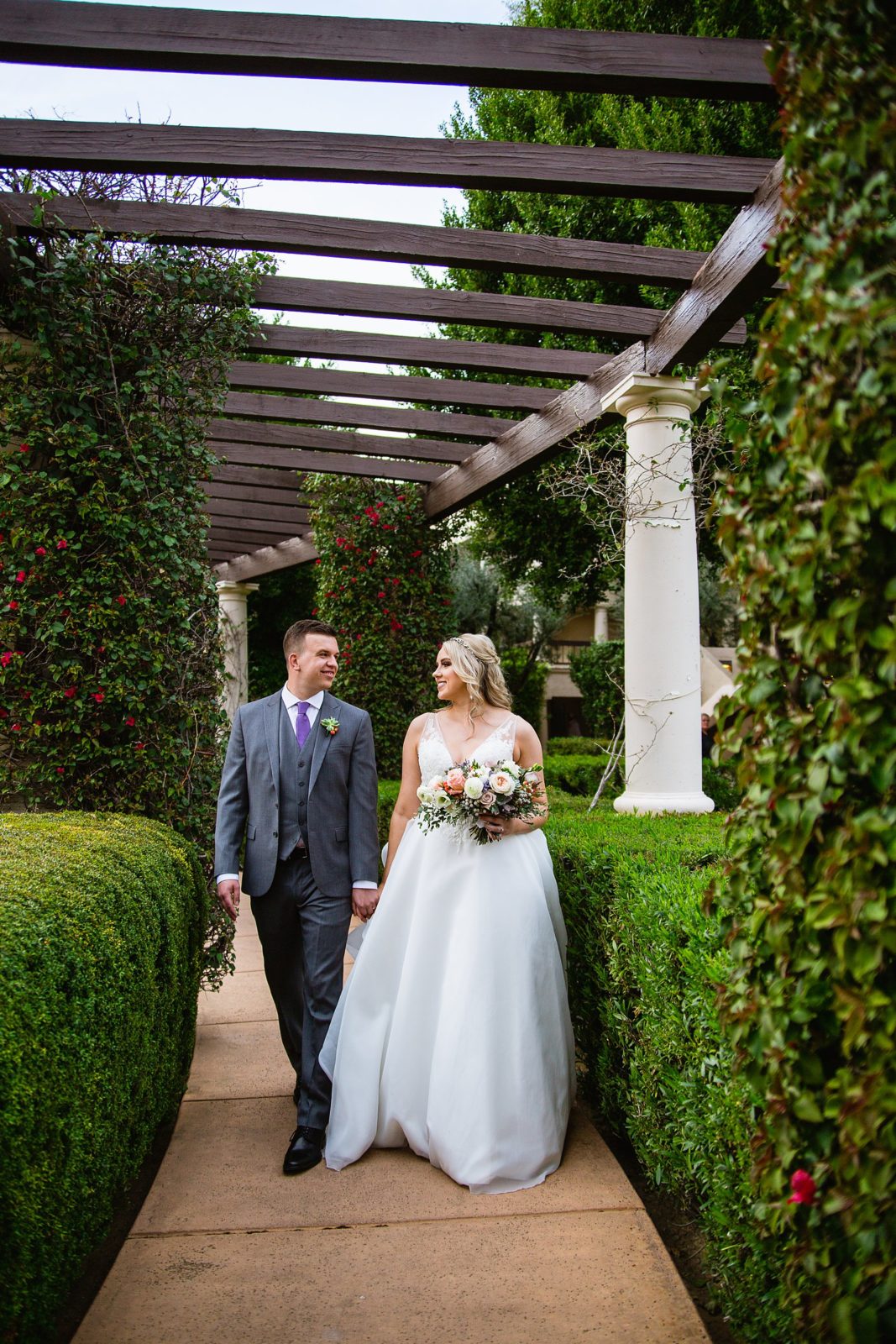 Bride and Groom walking together during their The Scottsdale Resort at McCormick Ranch wedding by Arizona wedding photographer PMA Photography.