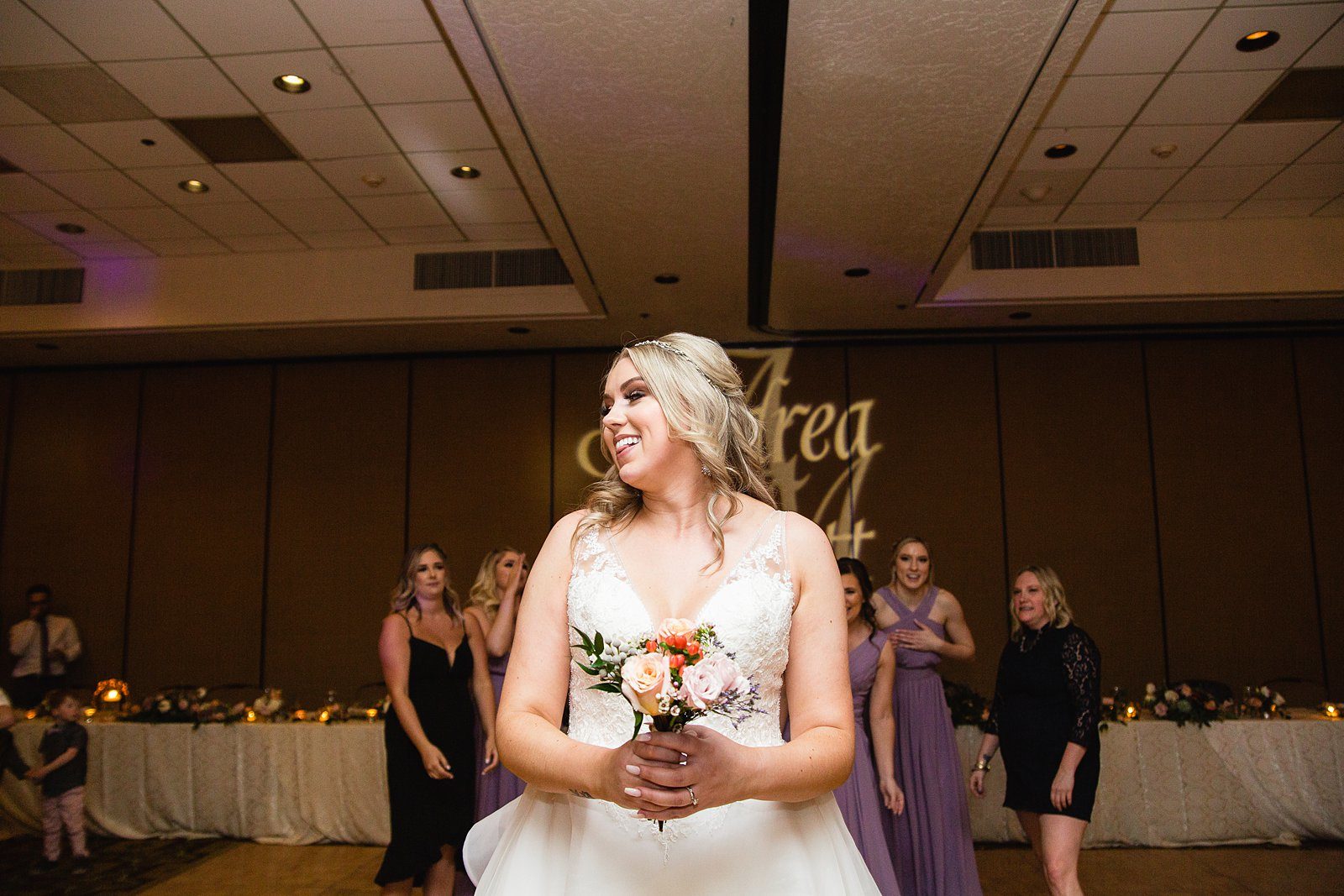 Bouquet toss at The Scottsdale Resort at McCormick Ranch wedding reception by Scottsdale wedding photographer PMA Photography.