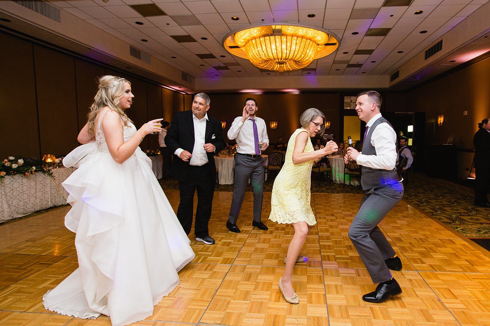 Bride and groom dancing with guests at The Scottsdale Resort at McCormick Ranch wedding reception by Scottsdale wedding photographer PMA Photography