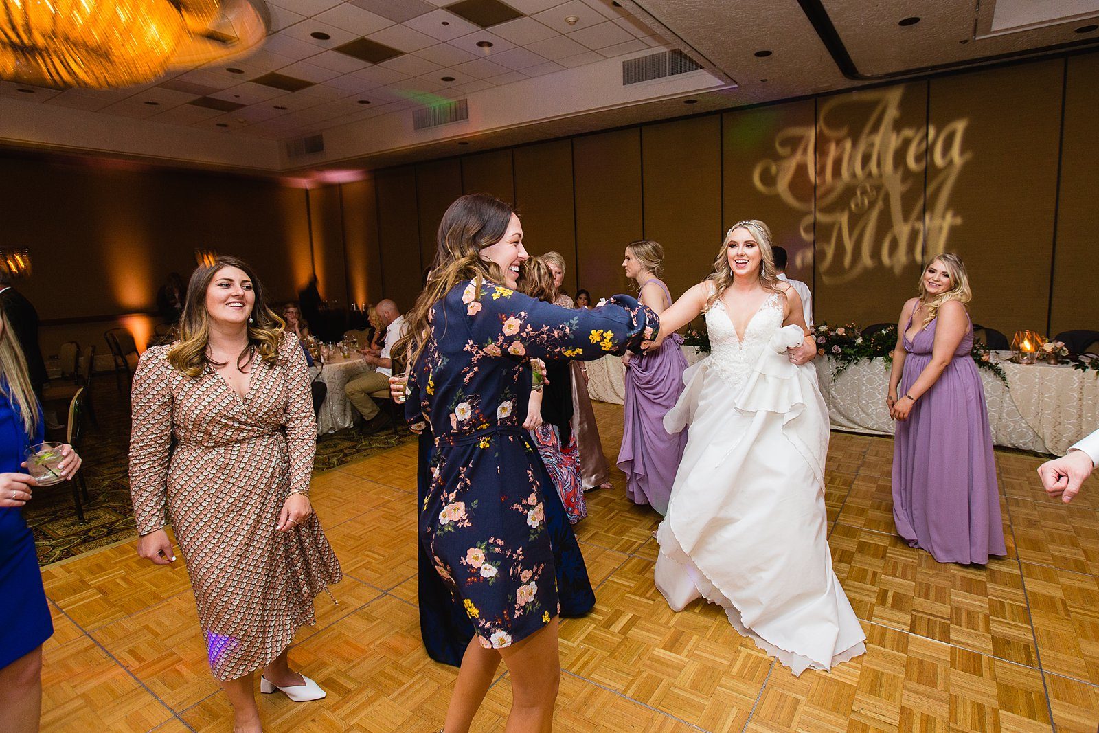 Bride dancing with guests at The Scottsdale Resort at McCormick Ranch wedding reception by Scottsdale wedding photographer PMA Photography