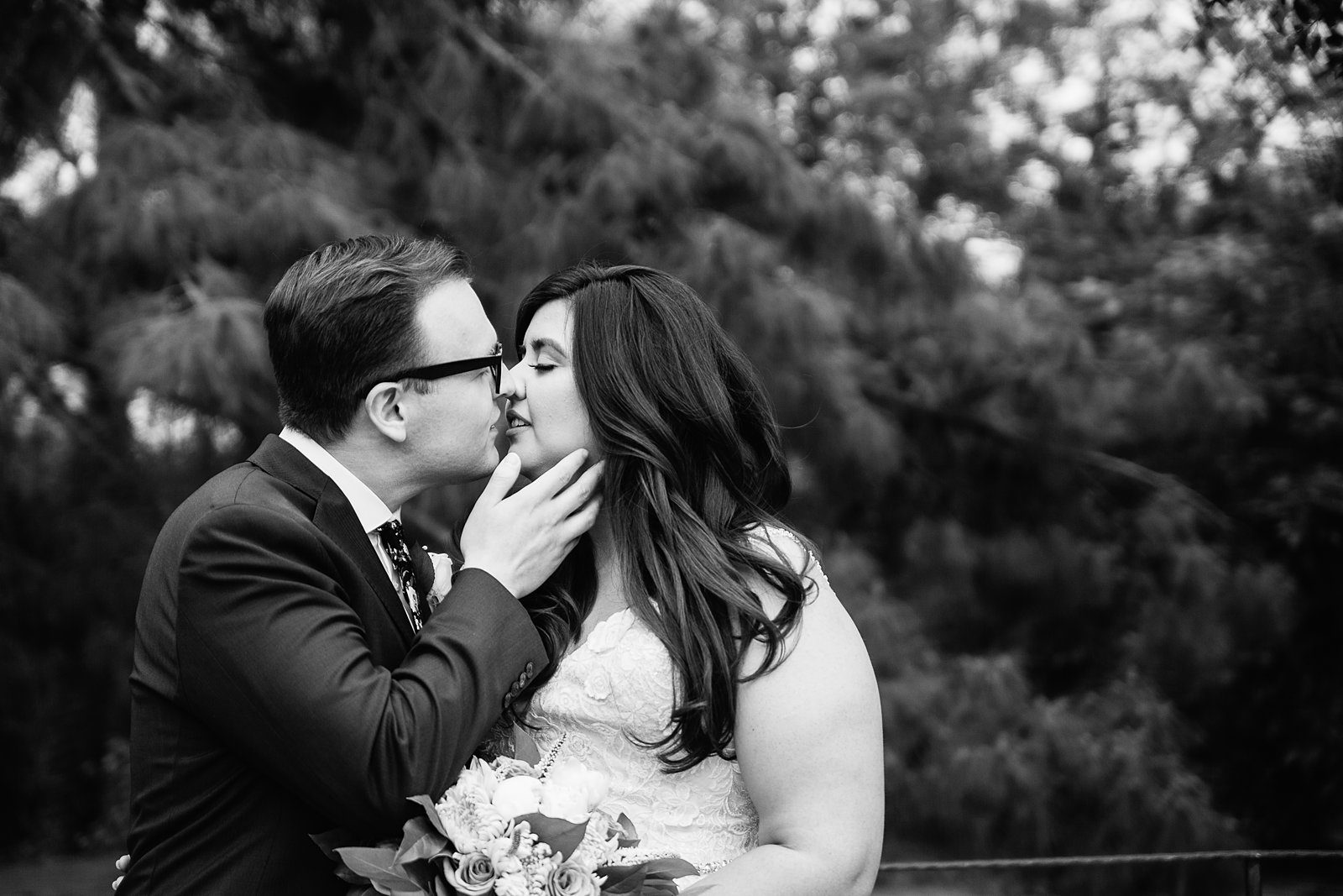 Bride and Groom share a kiss during their The Wright House Provencal wedding by Mesa wedding photographer PMA Photography.