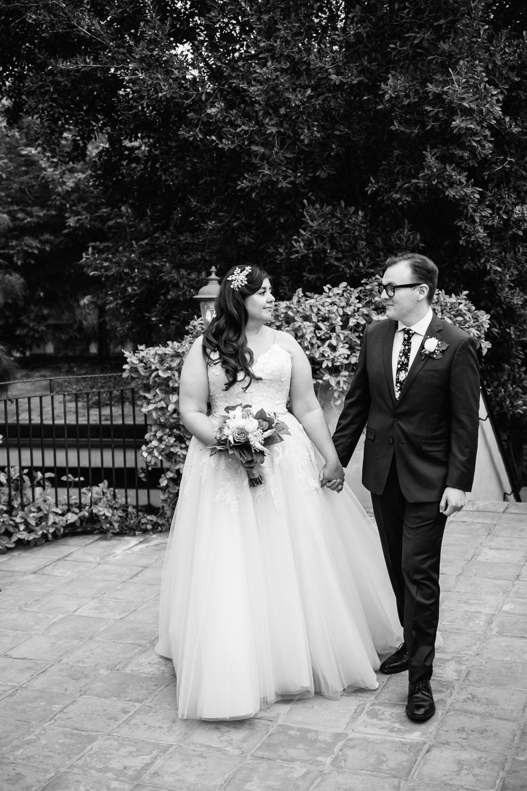 Bride and Groom walking together during their The Wright House Provencal wedding by Mesa wedding photographer PMA Photography.