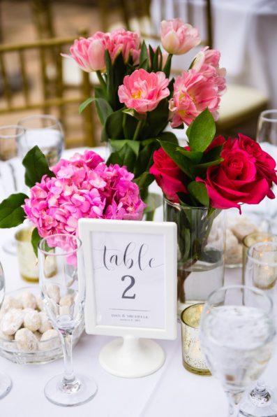 Pink floral garden wedding reception centerpiece by PMA Photography.