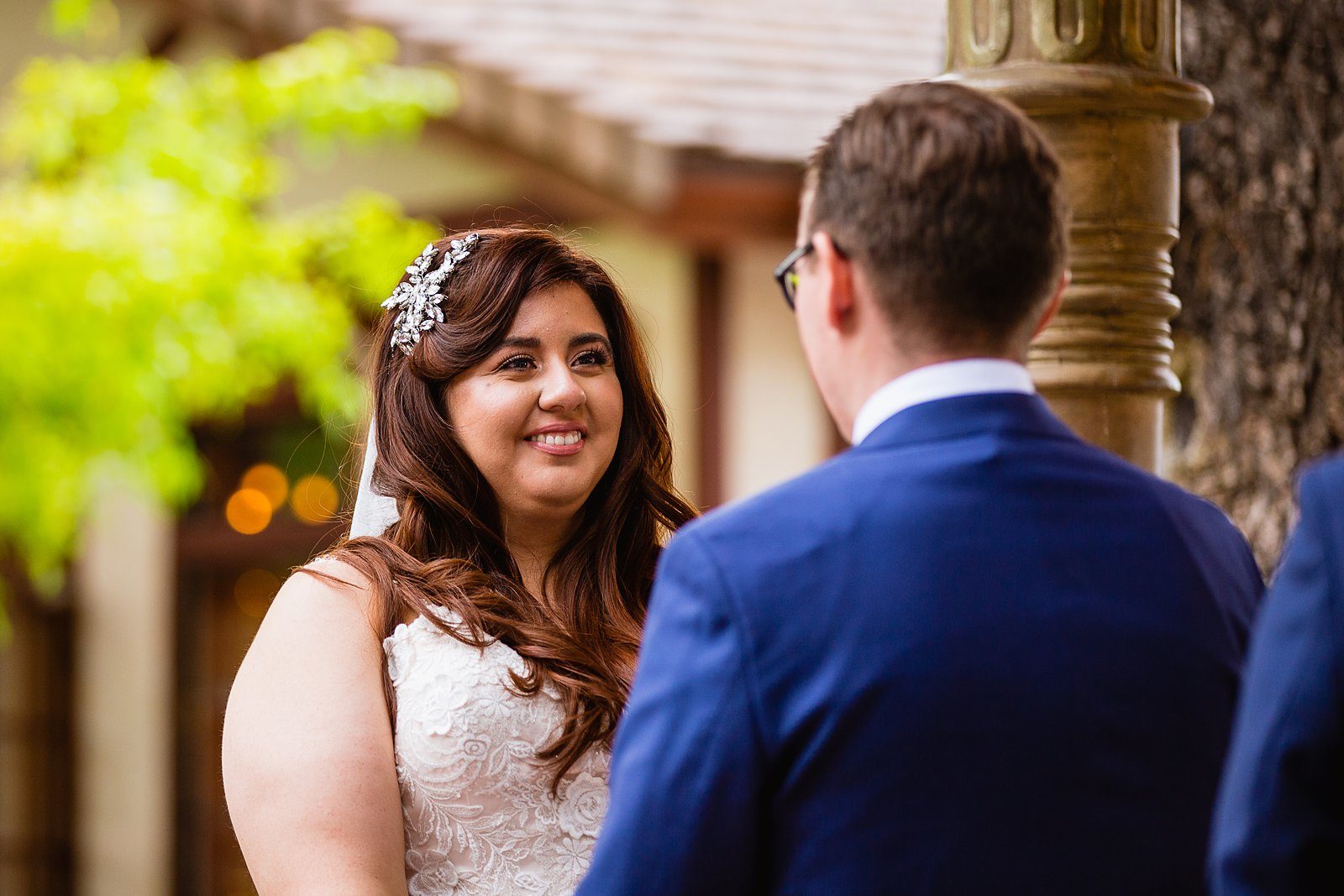 Bride looking at her groom during their wedding ceremony at The Wright House Provencal by Mesa wedding photographer PMA Photography.