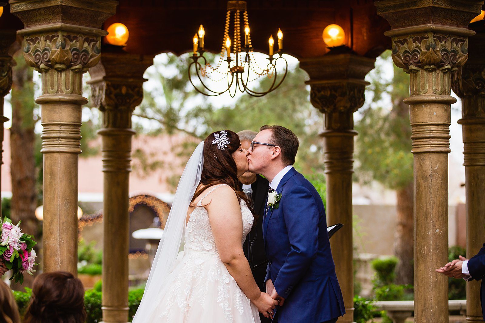 Bride and Groom share their first kiss during their wedding ceremony at The Wright House Provencal by Arizona wedding photographer PMA Photography.