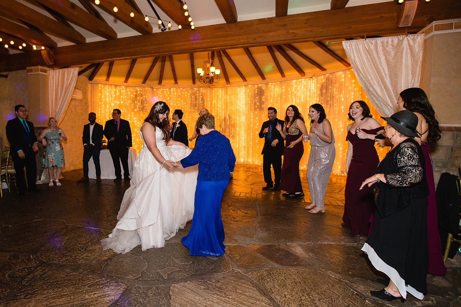 Bride dancing with guests at Wright House Provencal wedding reception by Mesa wedding photographer PMA Photography