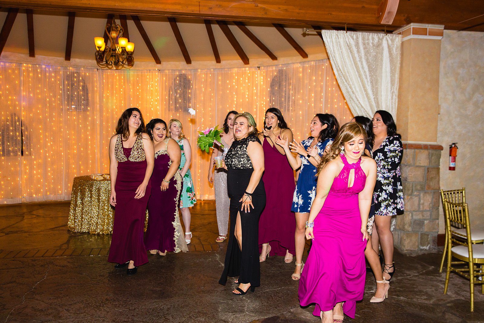 Bouquet toss at Wright House Provencal wedding reception by Mesa wedding photographer PMA Photography.