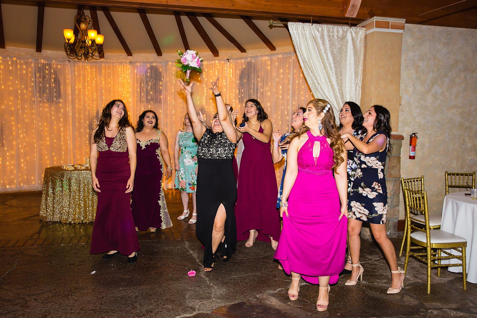 Bouquet toss at Wright House Provencal wedding reception by Mesa wedding photographer PMA Photography.