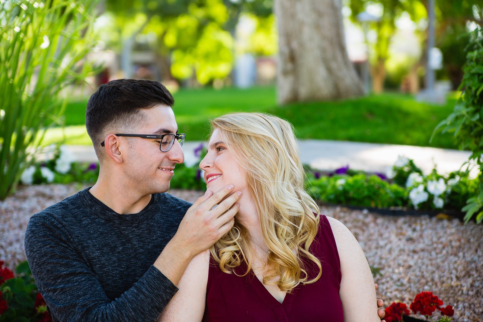 Couple share an intimate moment during their Scottsdale Civic Center engagement session by Scottsdale engagement photographer PMA Photography.