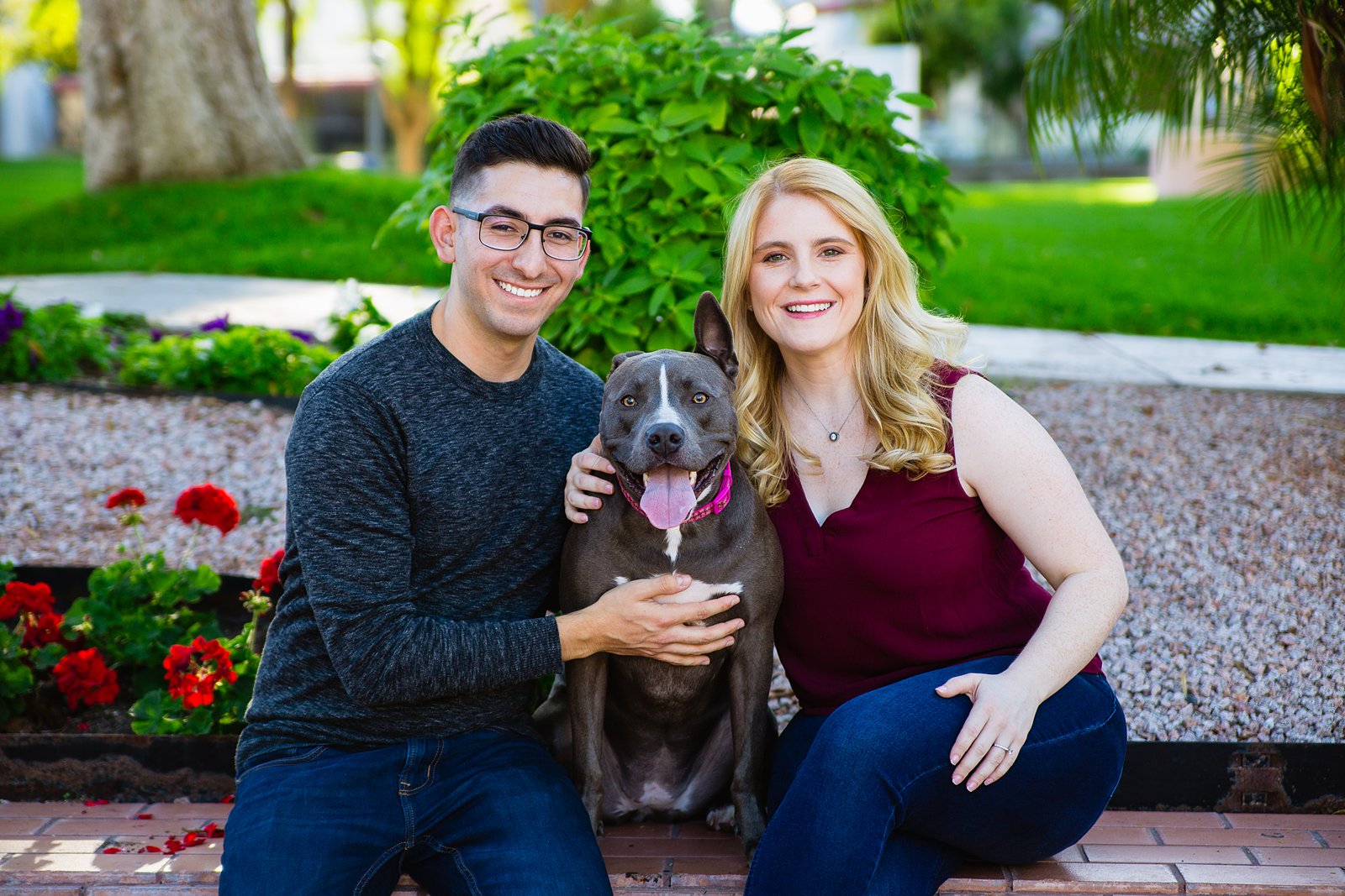 Couple pose with their dog for their Scottsdale Civic Center engagement session by Scottsdale wedding photographer PMA Photography.
