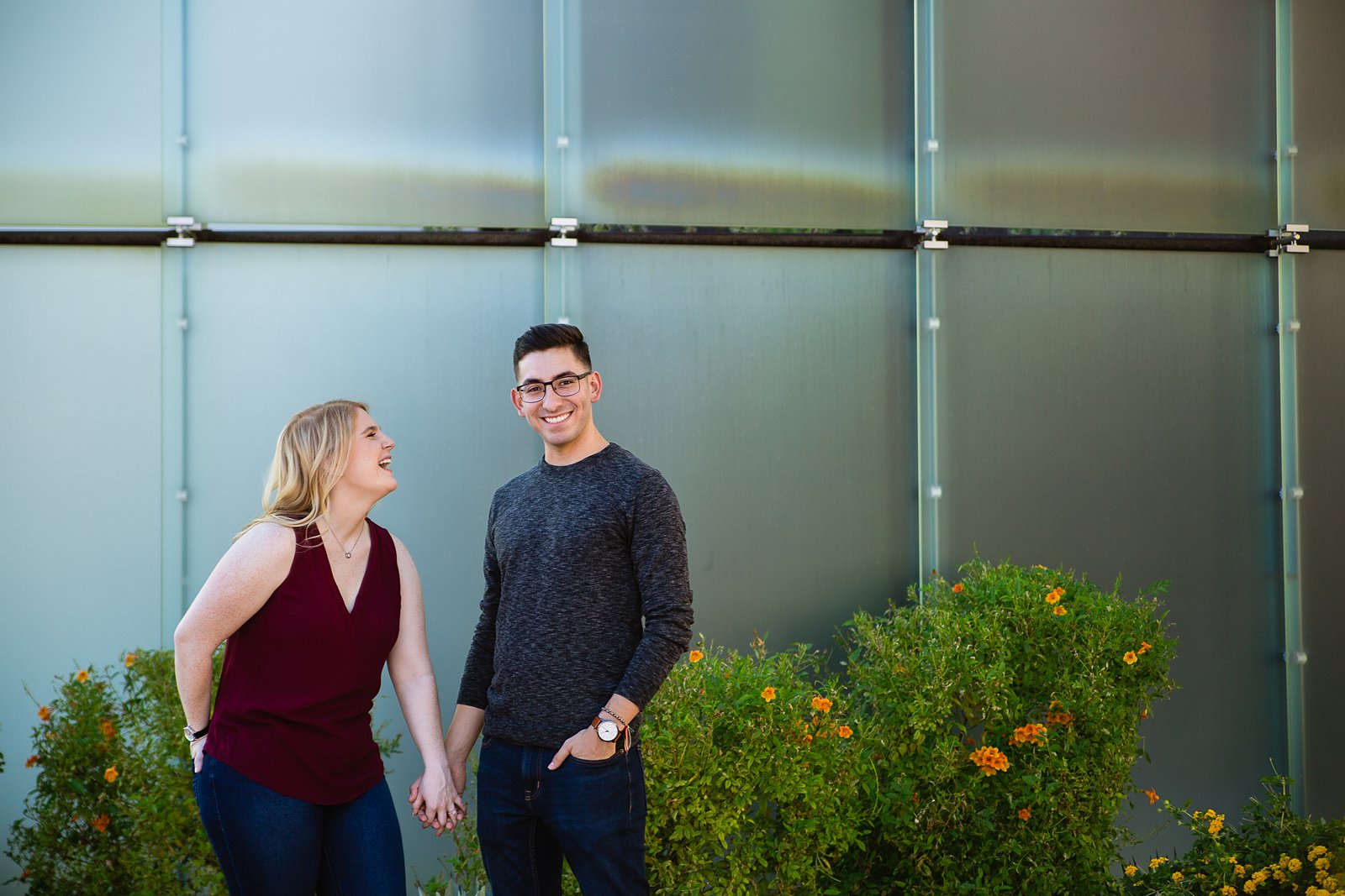 Couple laugh together during their Scottsdale engagement session by Arizona engagement photographer PMA Photography.