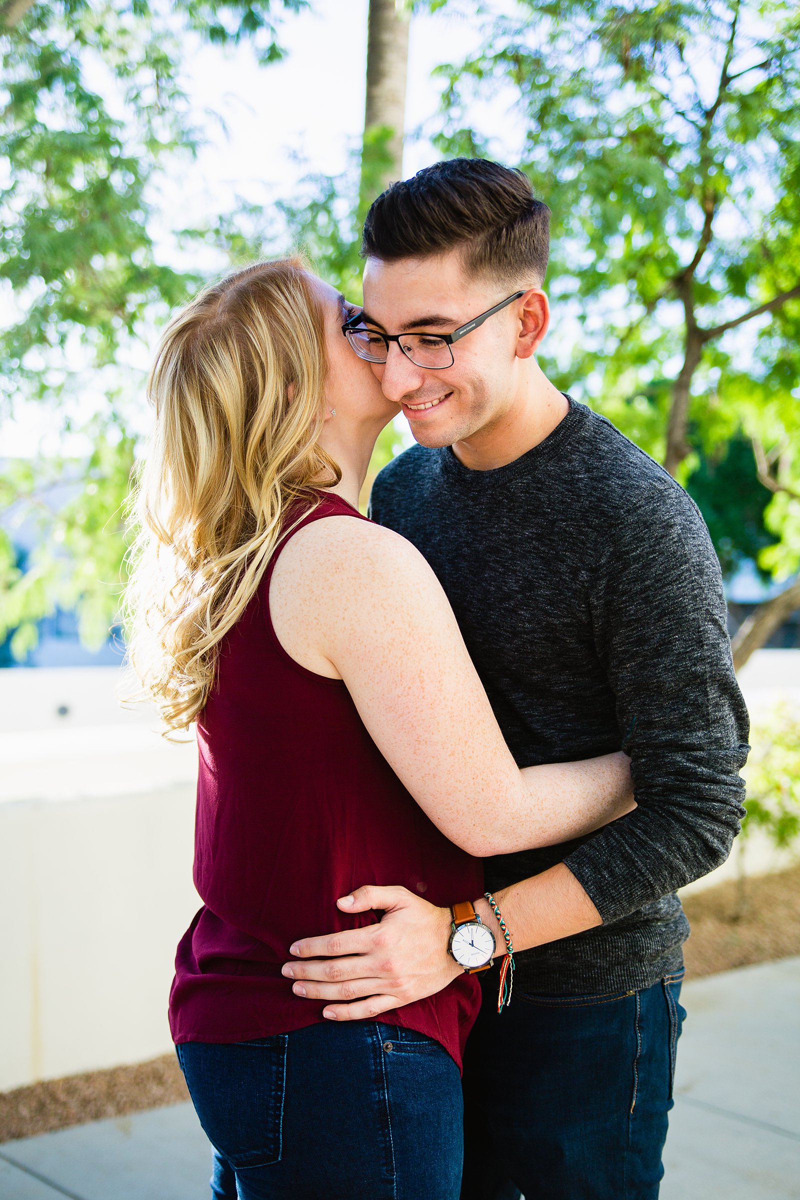 Couple share an intimate moment during their Scottsdale Civic Center engagement session by Scottsdale engagement photographer PMA Photography.