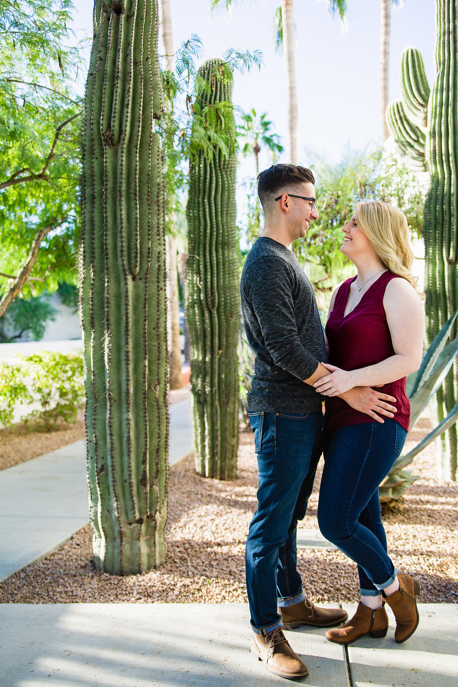 Couple pose during their Scottsdale engagement session by Arizona wedding photographer PMA Photography.