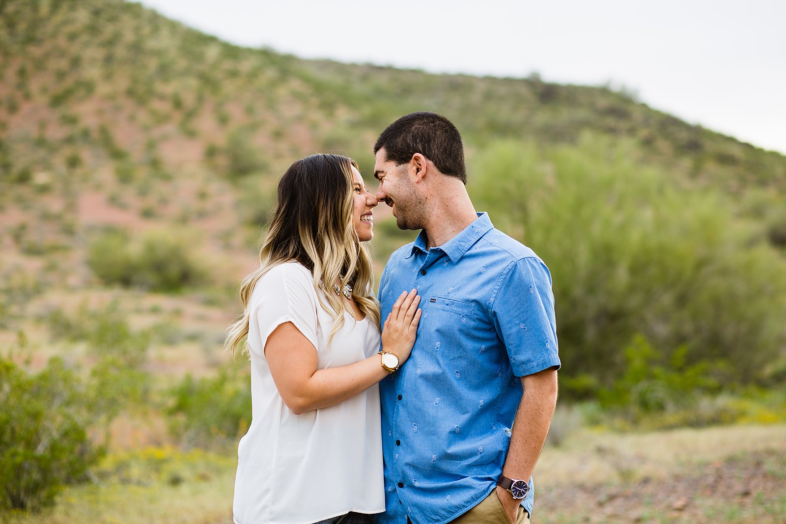 Couple share an intimate moment during their Thunderbird Mountain engagement session by Phoenix engagement photographer PMA Photography.