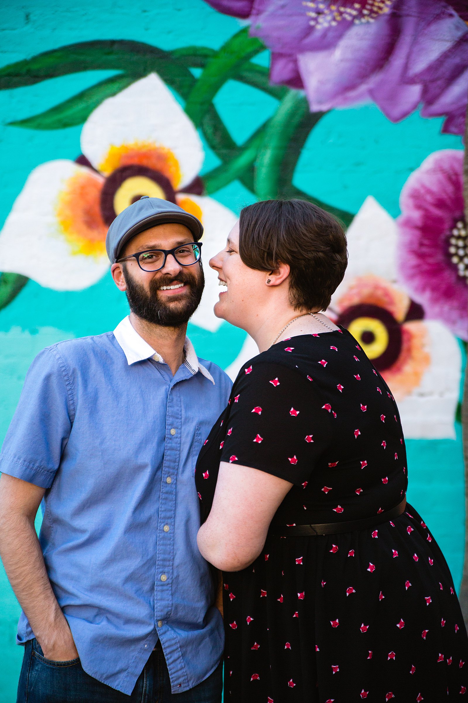 Couple laugh together during their Downtown Mesa engagement session by Phoenix engagement photographer PMA Photography.