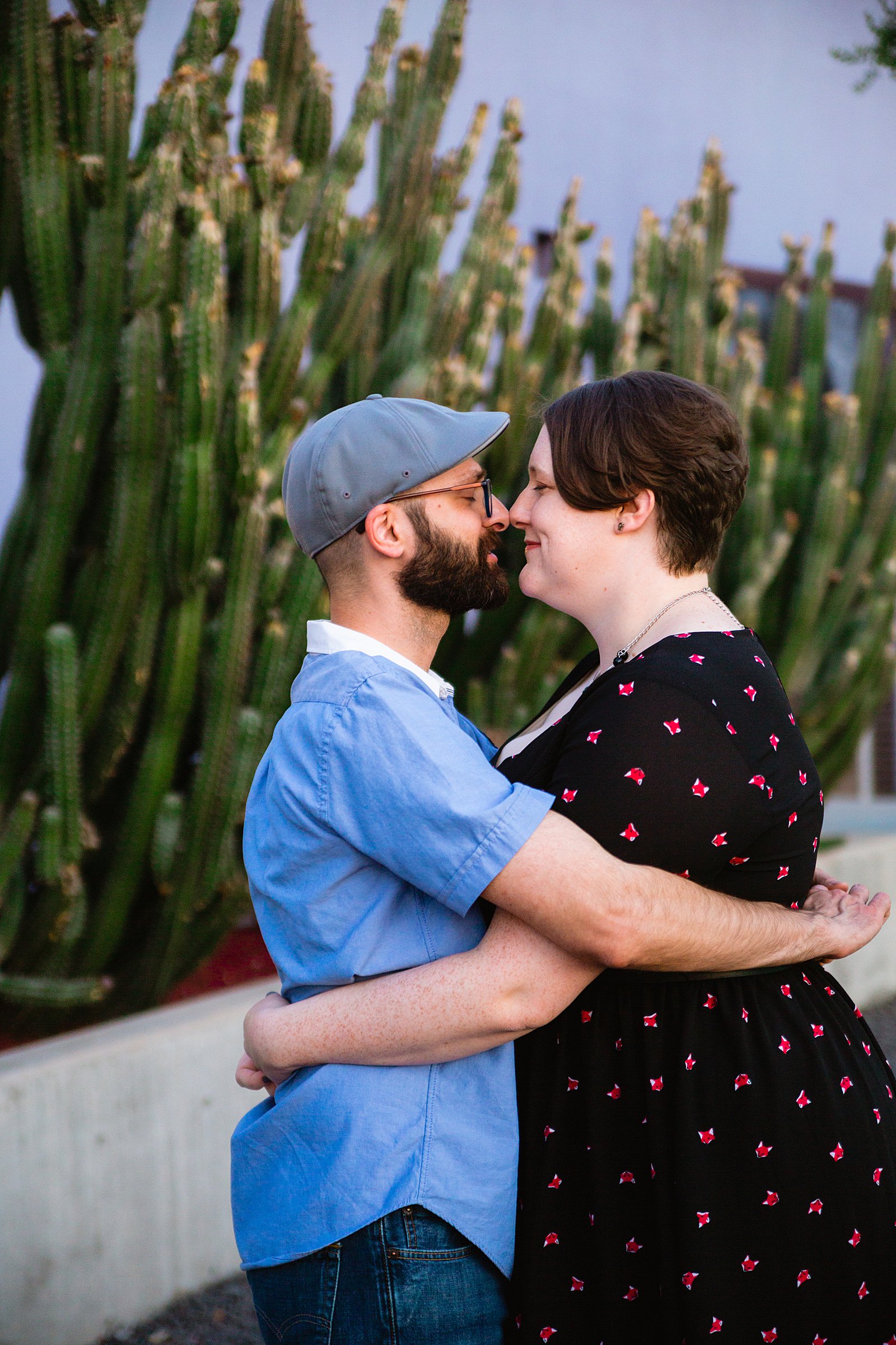 Couple share an intimate moment during their Mesa Arts Center engagement session by Phoenix engagement photographer PMA Photography.