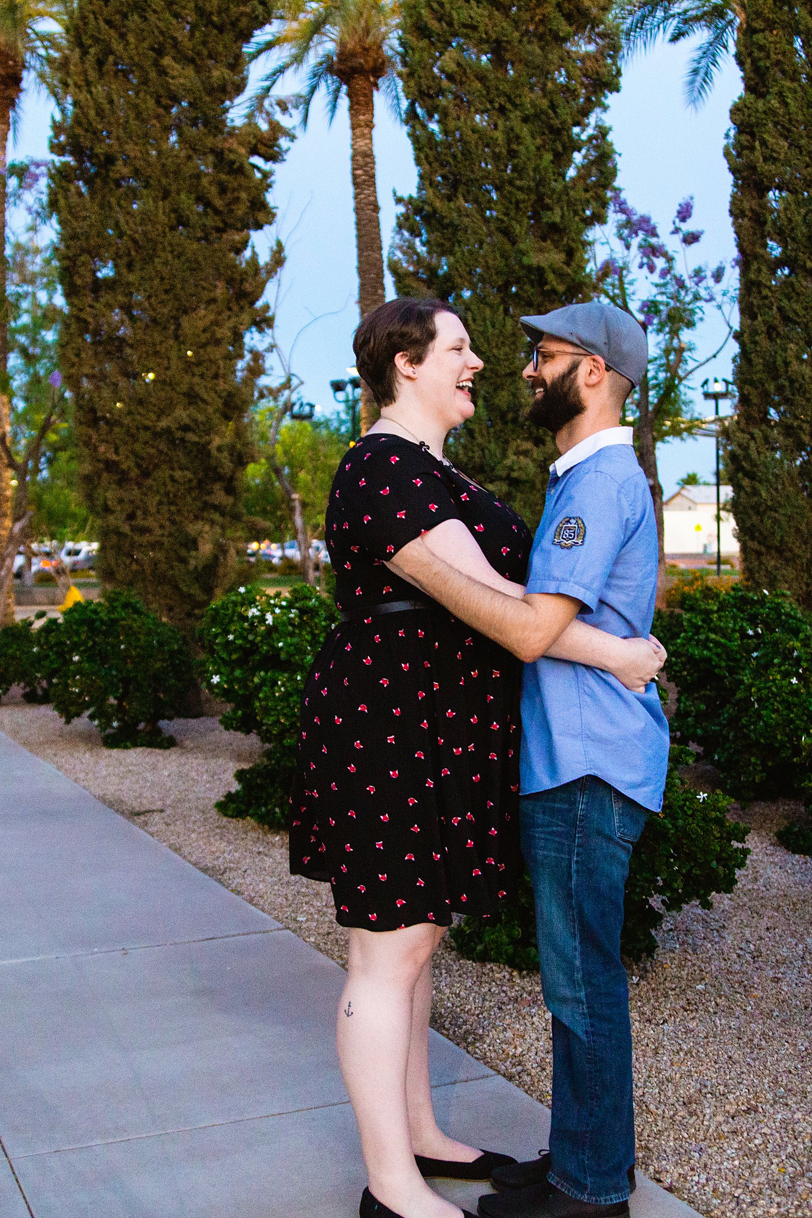 Couple laugh together during their Mesa Arts Center engagement session by Phoenix engagement photographer PMA Photography.