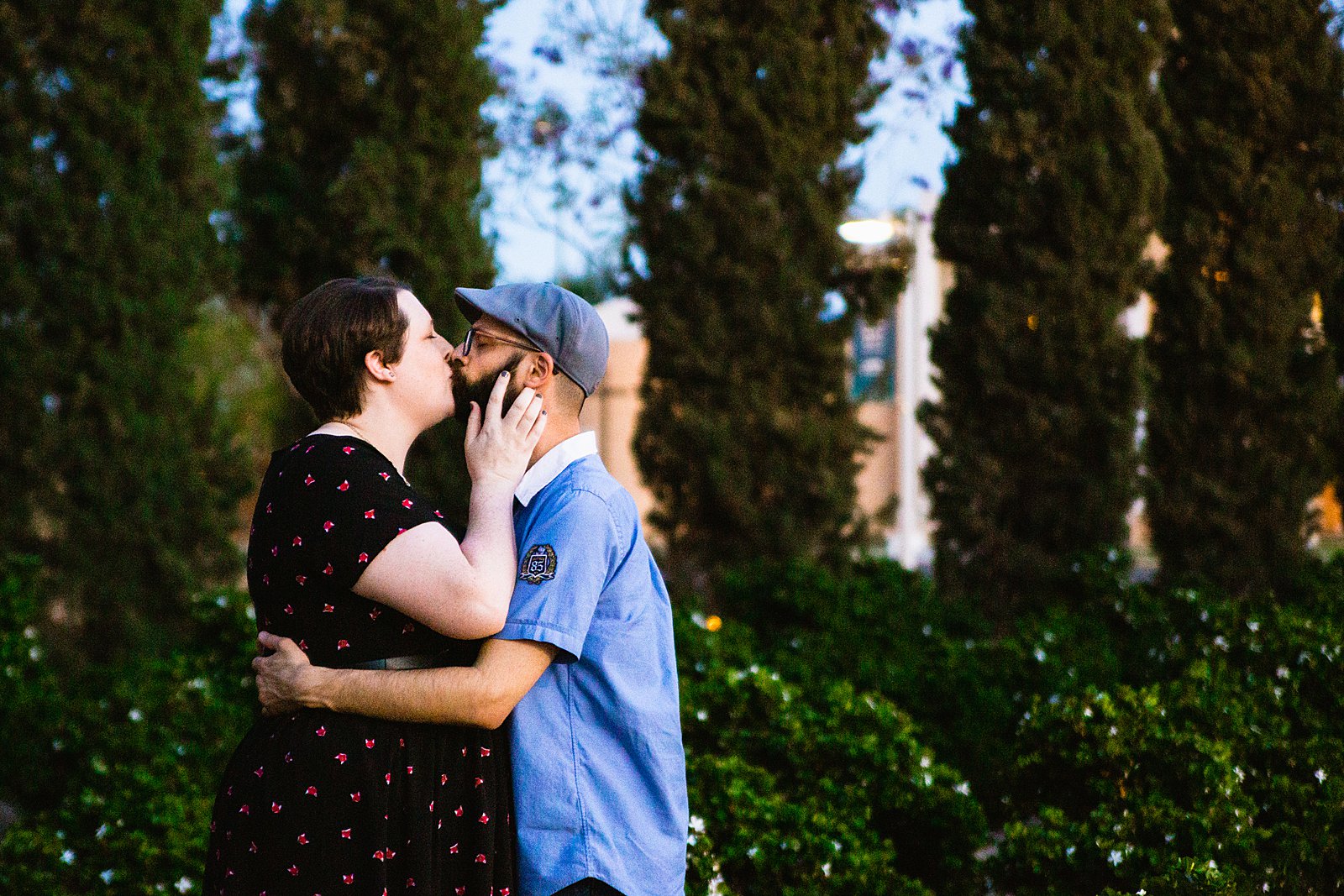 Couple share a kiss during their Mesa Arts Center engagement session by Phoenix wedding photographer PMA Photography.