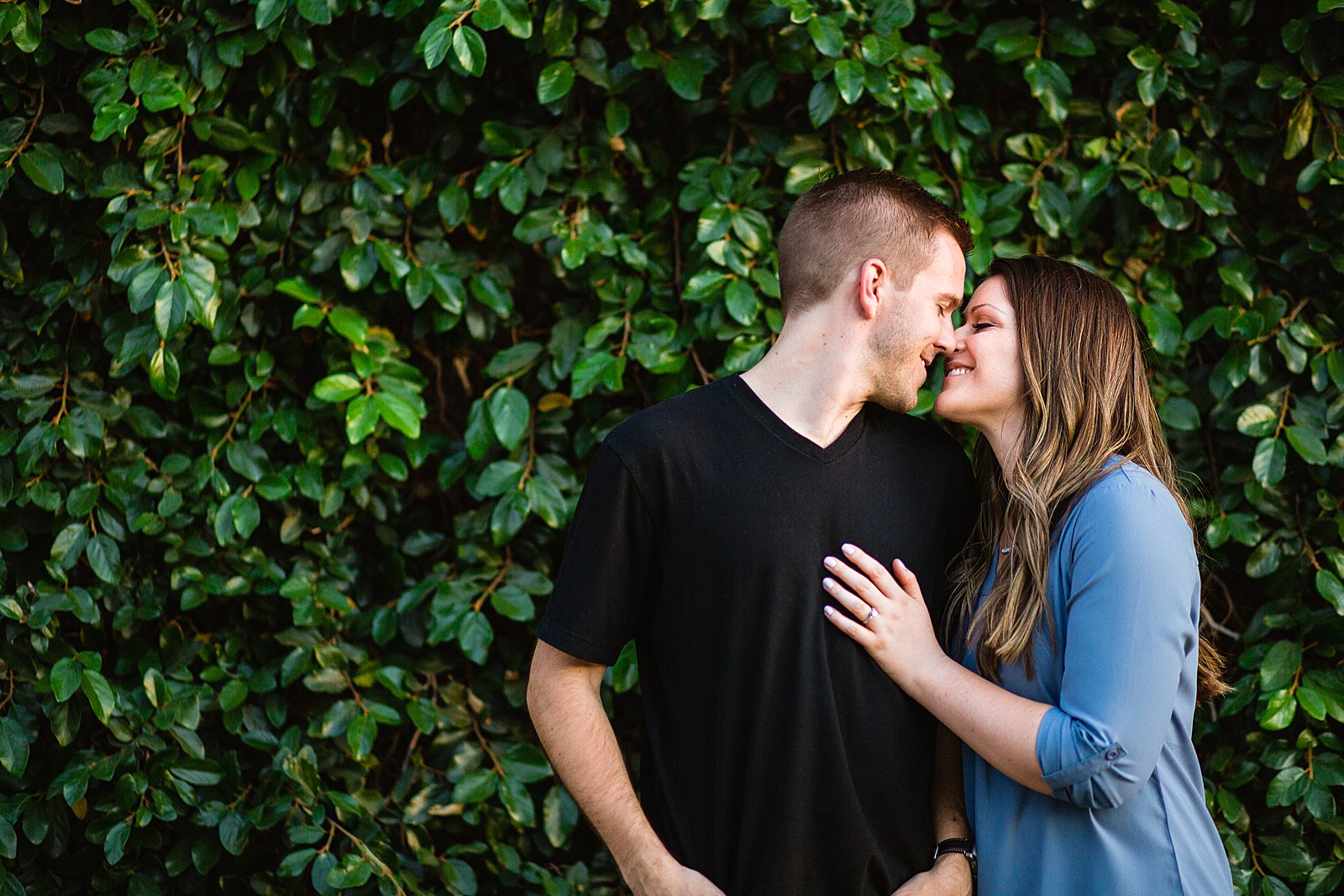 Couple share an intimate moment during their Roosevelt Row engagement session by Phoenix engagement photographer PMA Photography.