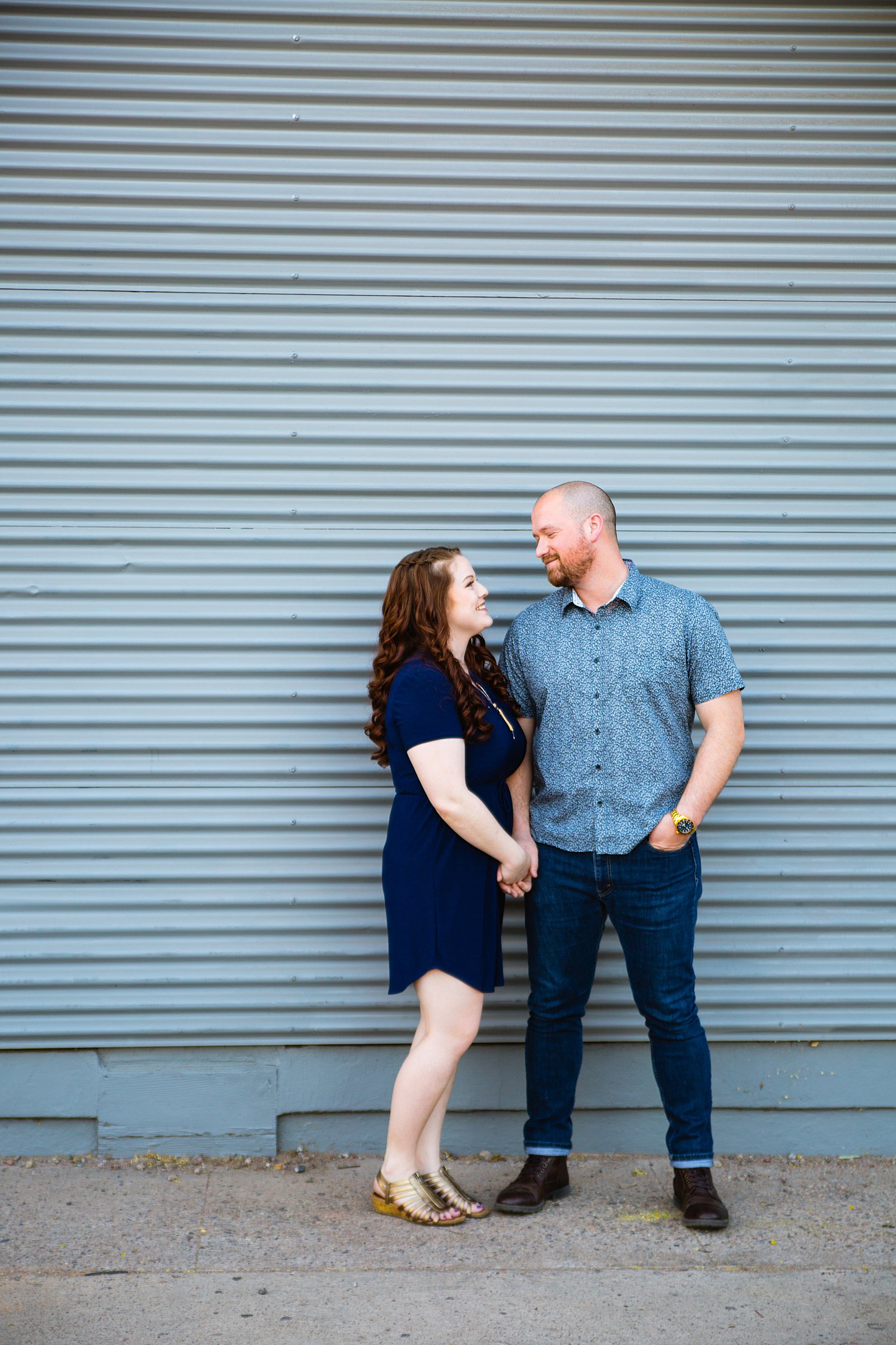 Couple pose for their Roosevelt Row engagement session by Phoenix wedding photographer PMA Photography.