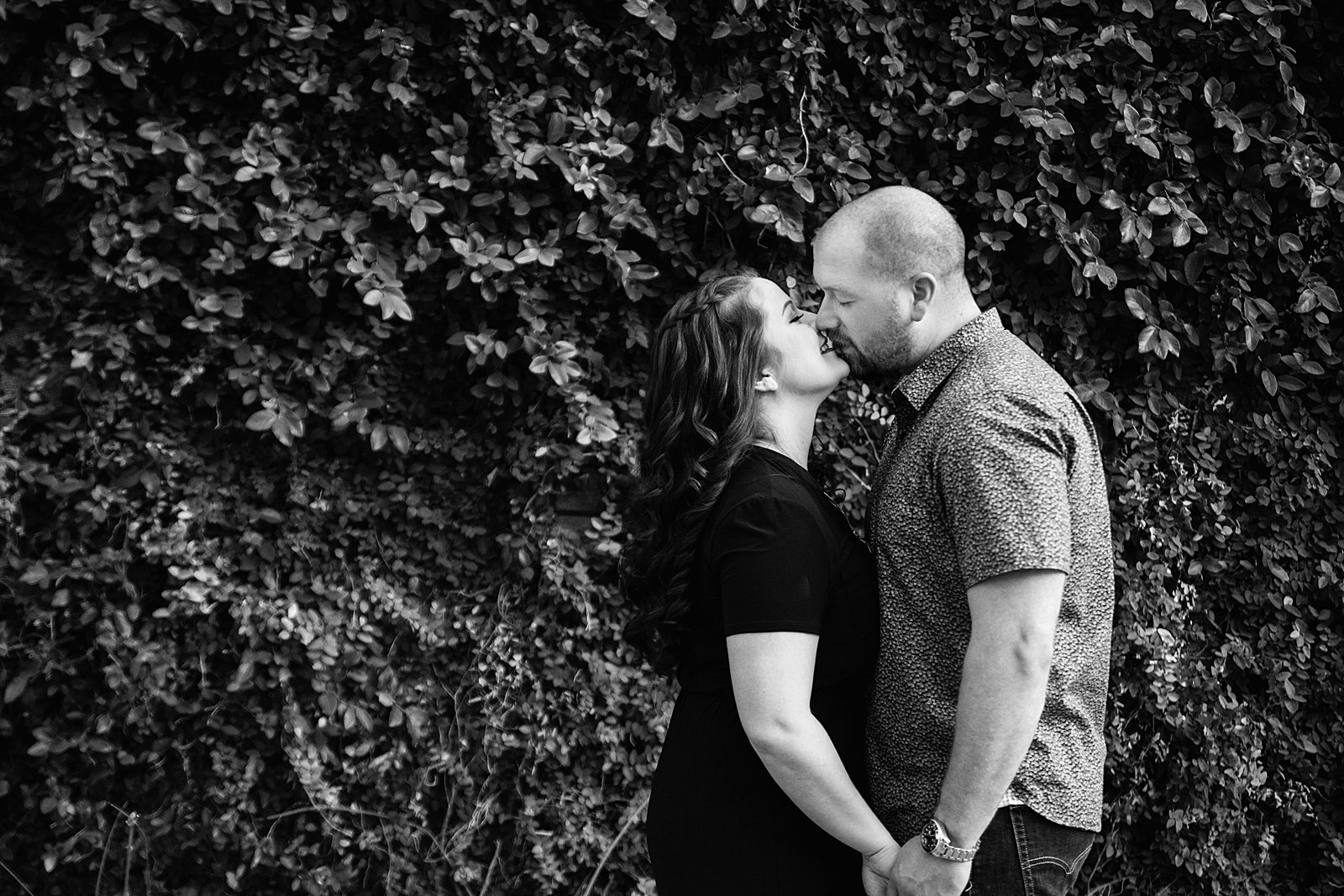 Couple share an intimate moment during their Roosevelt Row engagement session by Phoenix engagement photographer PMA Photography.