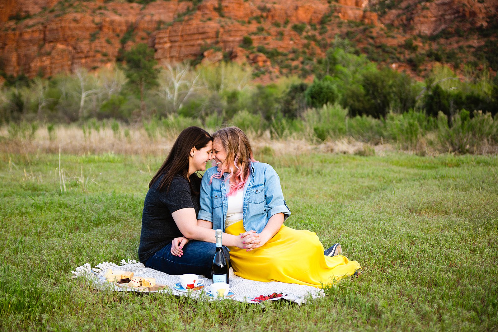LGBT enjoy a picnic at Crescent Moon Ranch during their engagement session by Sedona wedding photographer PMA Photography.
