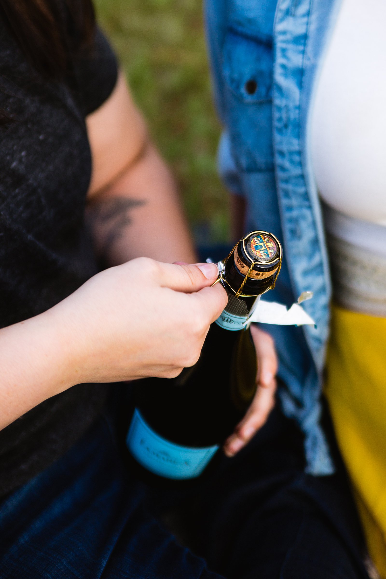 Popping champagne during a picnic engagement session in Sedona by PMA Photography.