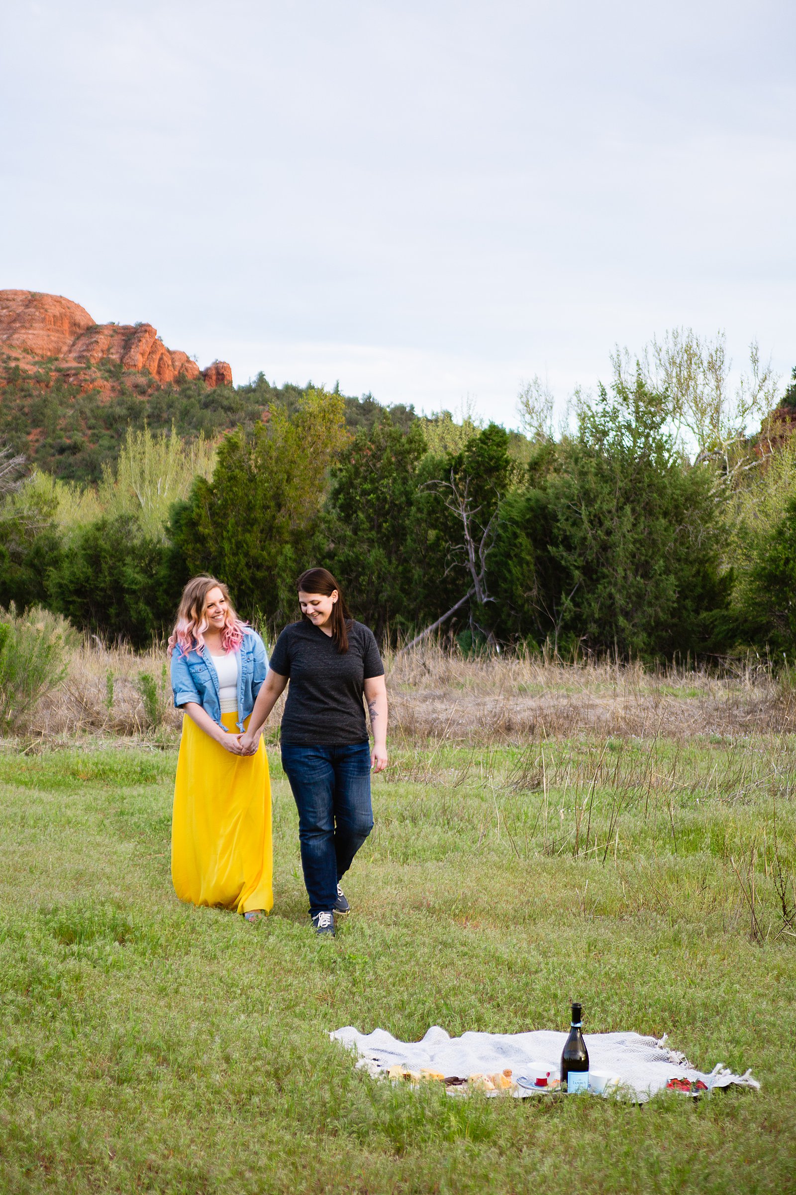 Same Sex couple walking together during their Sedona engagement session by Arizona engagement photographer PMA Photography.