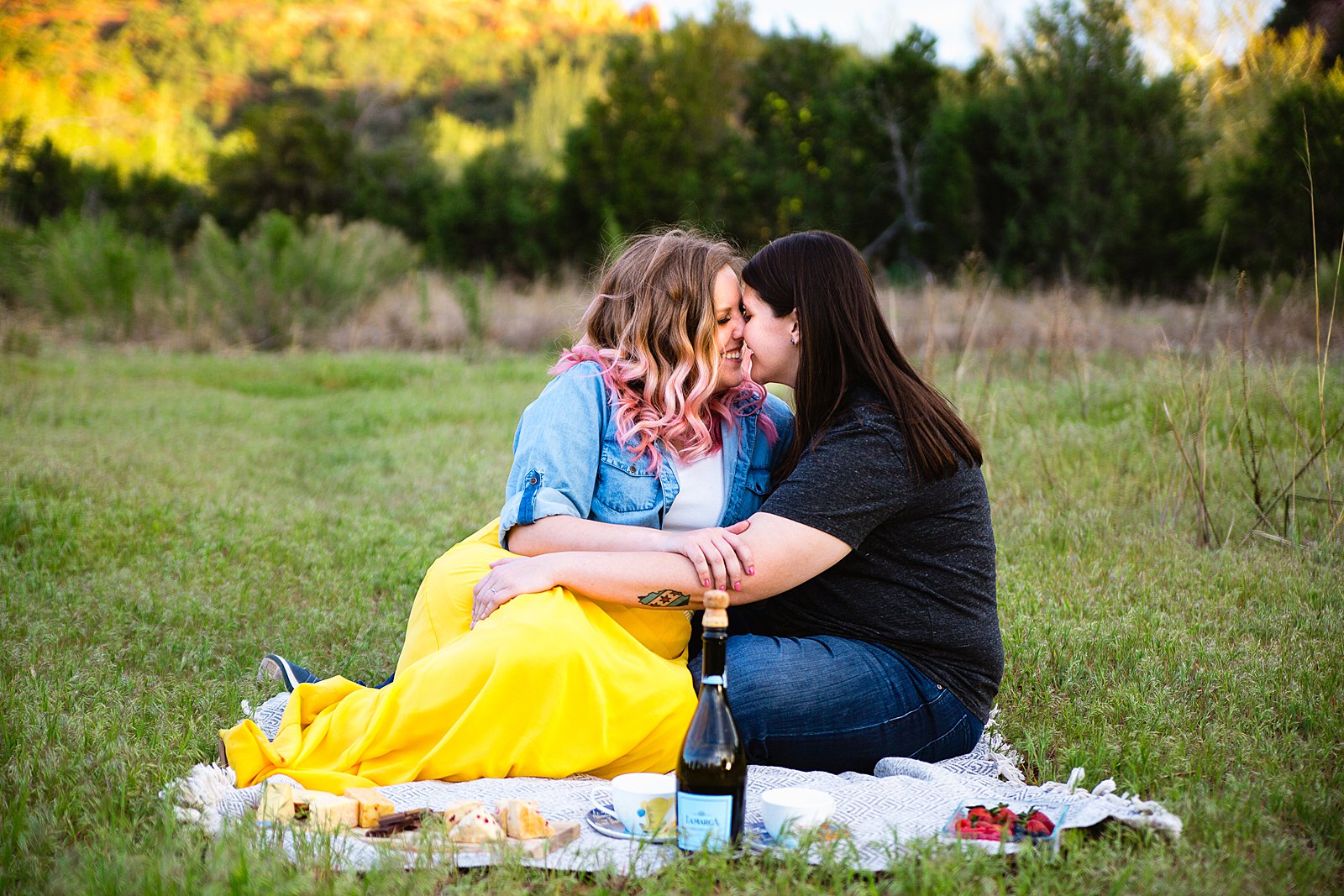 LGBTQ enjoy a picnic at Crescent Moon Ranch during their engagement session by Sedona wedding photographer PMA Photography.