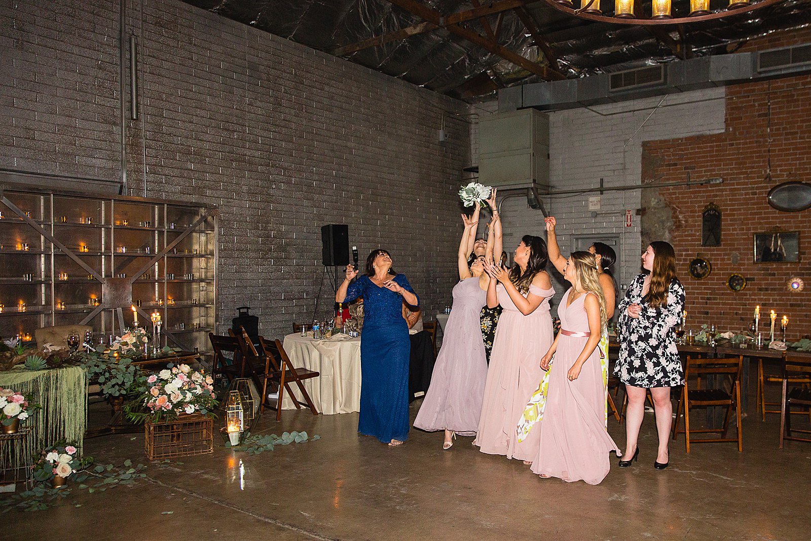 Bouquet toss at The Ice House wedding reception by Phoenix wedding photographer PMA Photography.