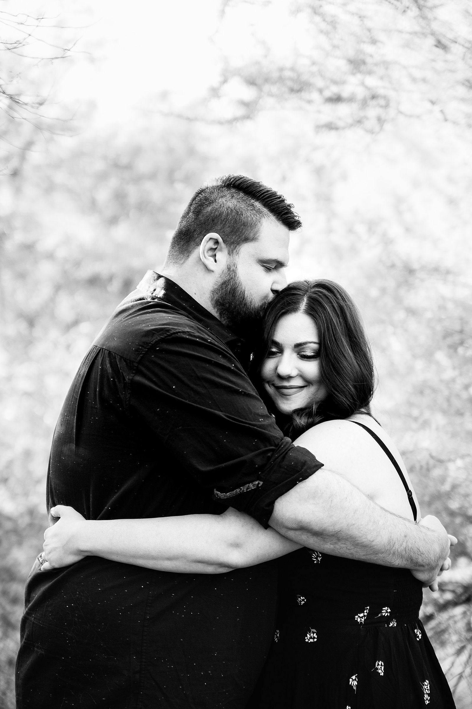 Couple share an intimate moment at their Phoenix engagement session by Arizona engagement photographer PMA Photography.