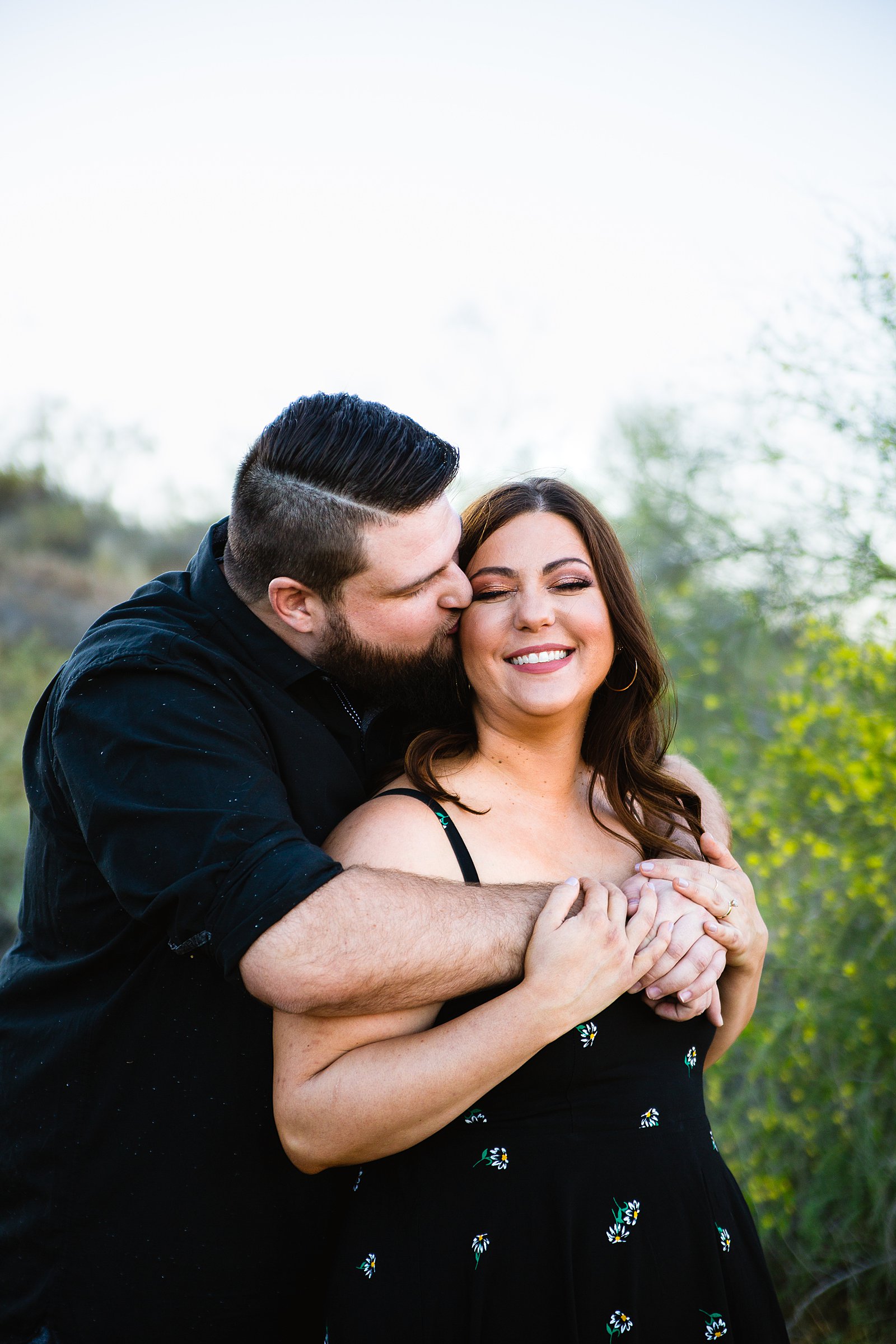 Couple laugh together during their Thunderbird Mountain engagement session by Phoenix engagement photographer PMA Photography.